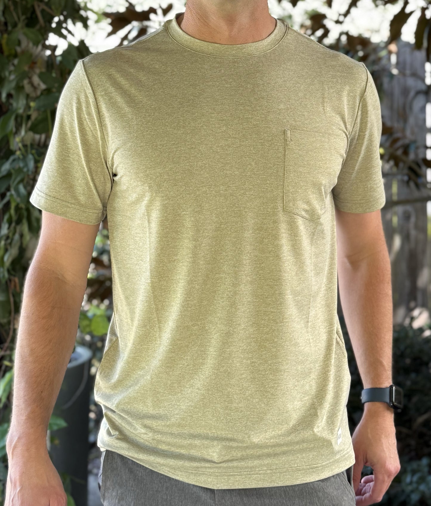 Alon's "Moss" Shades of NOLA Pro Pocket Tee in light green heather fabric with 4-way stretch and moisture wicking properties.