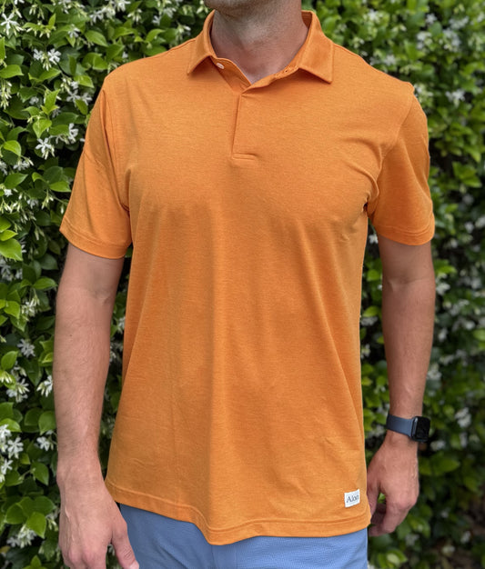 Man wearing Alon's Satsuma orange Bond Polo with company word mark patch