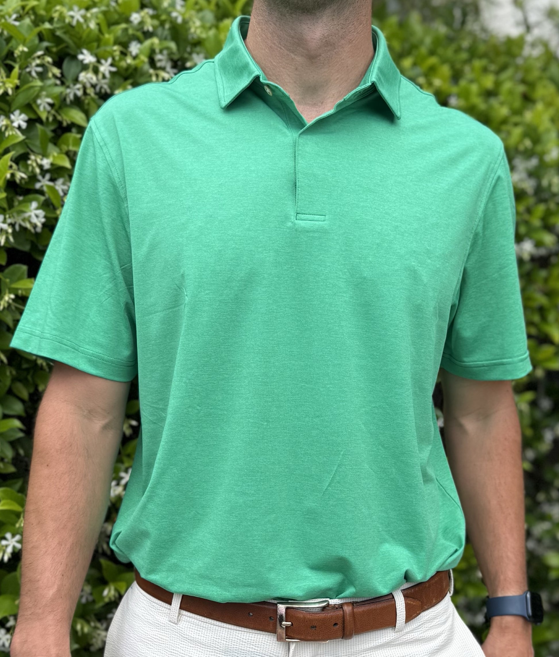 Man wearing Alon's Cafe green Bond Polo with company word mark patch