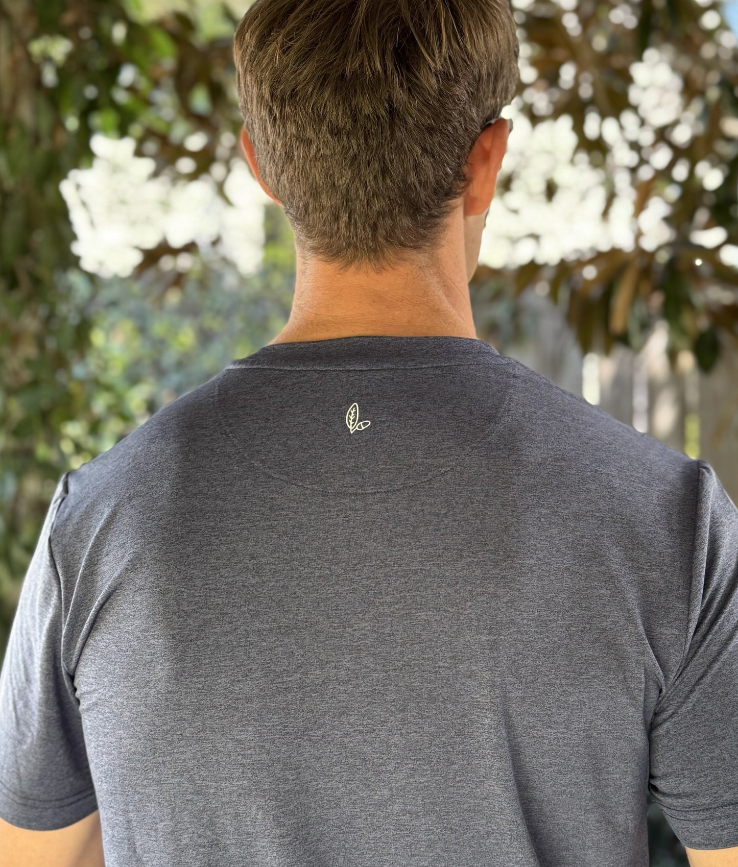 Alon's "Lagoon" Shades of NOLA Pro Pocket Tee in deep blue heather fabric with 4-way stretch and moisture wicking properties. 