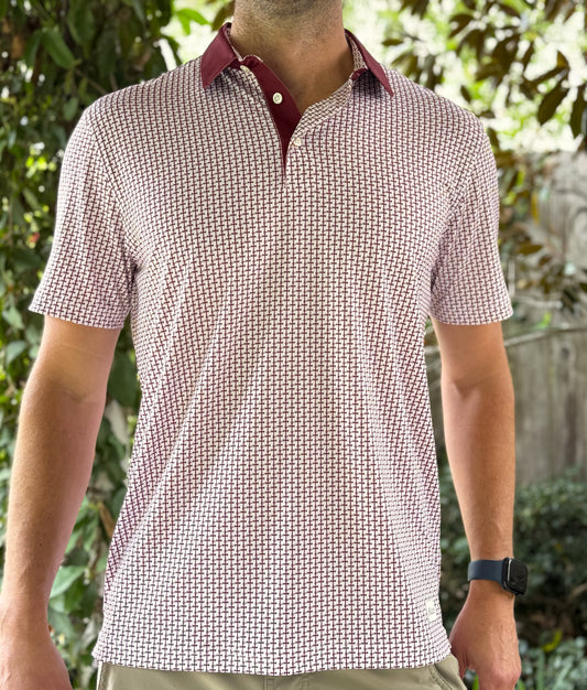 Crimson colored Lasallian cross patterned polo over white fabric.