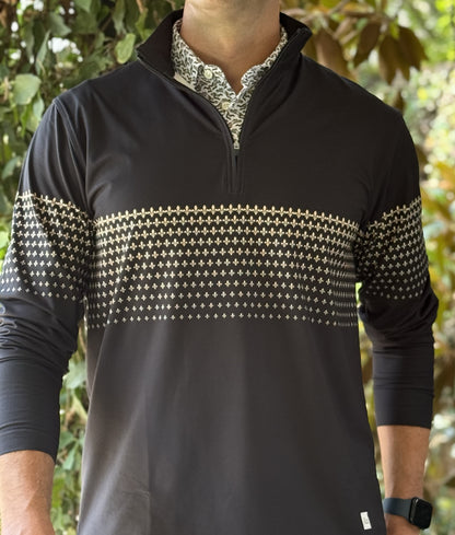 A man wearing a black quarter zip with a New Orleans Saints themed gold fleurs-de-lis pattern