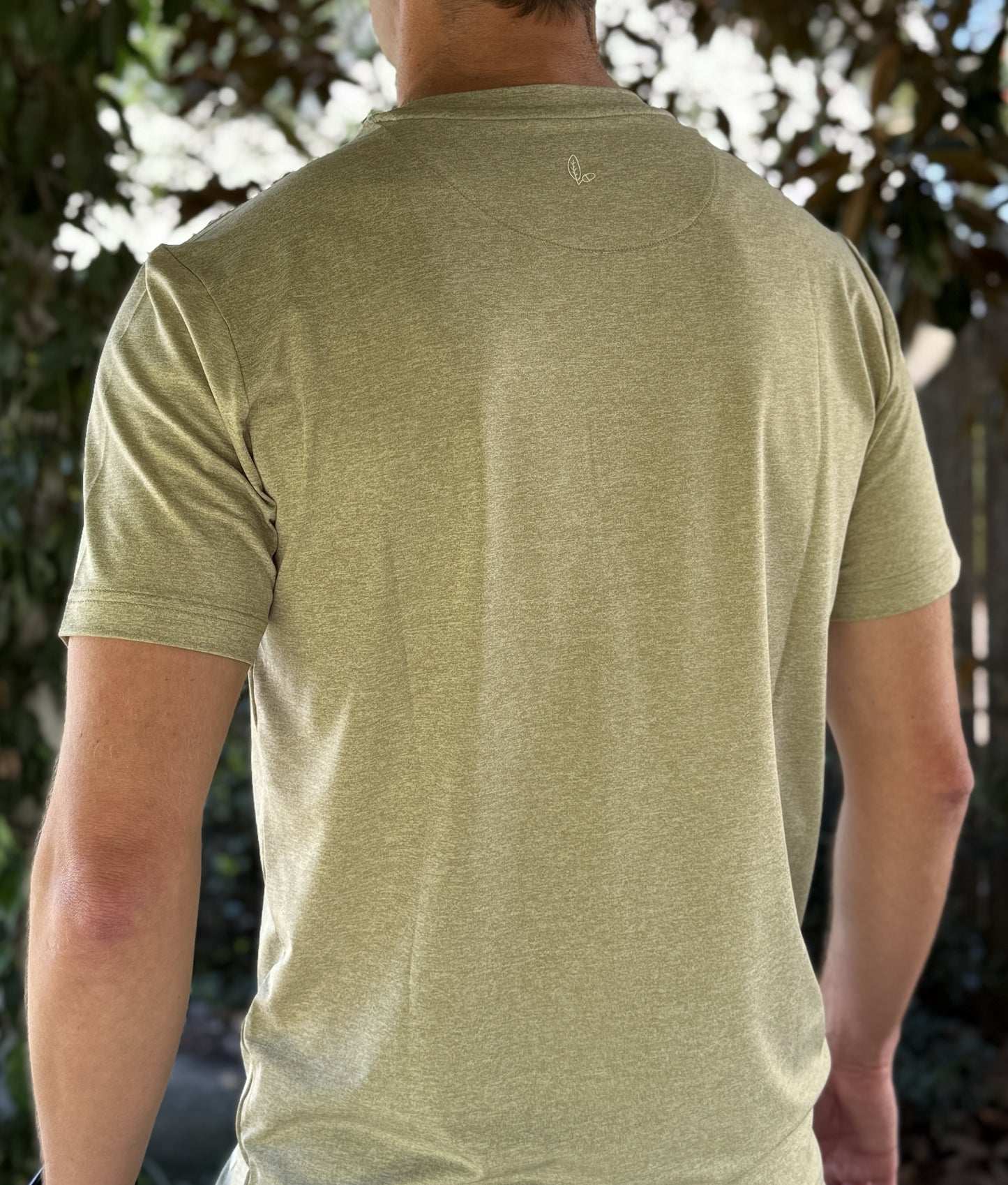 Alon's "Moss" Shades of NOLA Pro Pocket Tee in light green heather fabric with 4-way stretch and moisture wicking properties. 