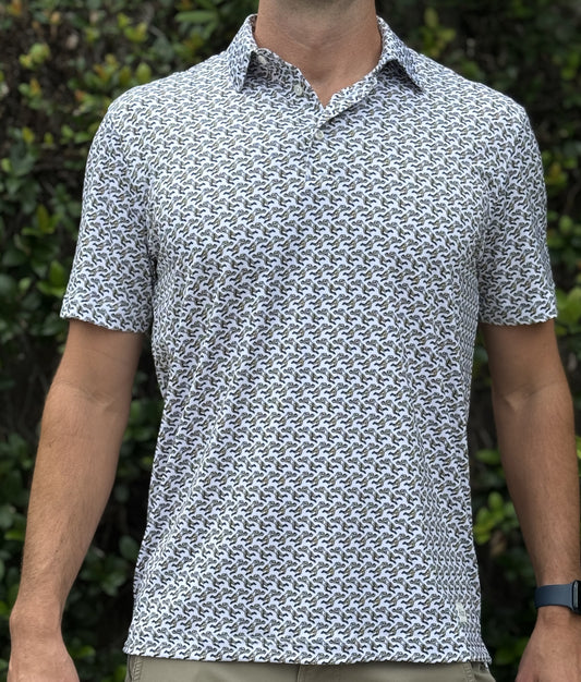 Man wearing a patterned polo shirt that features the famous Rebirth blocked punt for the New Orleans Saints