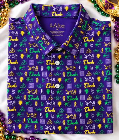A folded polo shirt with a purple base and an all-over repeating pattern of green, gold, and lavender Thoth/Egyptian themed icons.